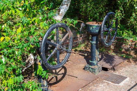 Flint, Flintshire; UK: Sept 17, 2020: Old manually operated sluice gate valves at Flint Dock remain, but not used. The manufacturer name, Blakeborough Valves of Brighouse is stamped on the foot platesのeditorial素材