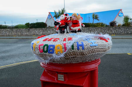 Rhyl, UK. Dec 25, 2021. A yarn bombing on a post box which features a Santa Dash is seen here on Christmas Day in the North Wales resort town of Rhylのeditorial素材