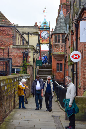 Chester, UK; Jul 3, 2022; Tourists enjoy exploring the Chester City Walls adjacent to the Eastgate Clock.のeditorial素材