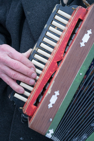 The aged hands of a gentleman accordion player from Russiaの写真素材