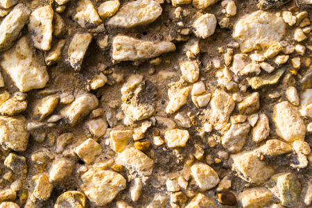 Stone ships and gravel cemented to a wallの写真素材