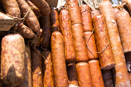 Dried smoked sausages for sale at a local marketの写真素材