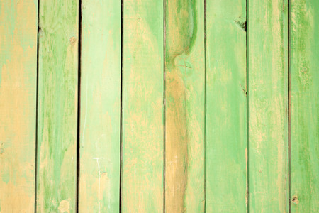 Green painted wooden slats and planks fading with the yearsの写真素材