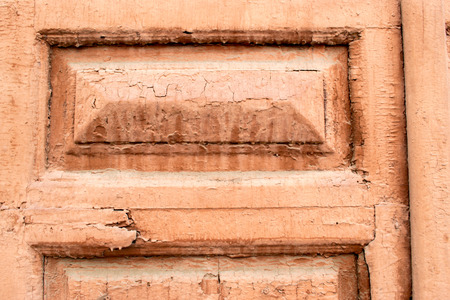 Closeup of a fading painted door with bevelling and paint flakesの写真素材