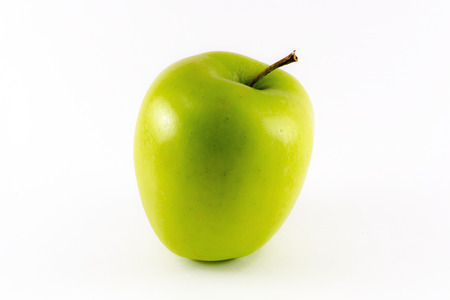 A golden yellow apple isolated on a white backgroundの写真素材