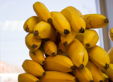 A bunch of bananas on display at a market stallの写真素材