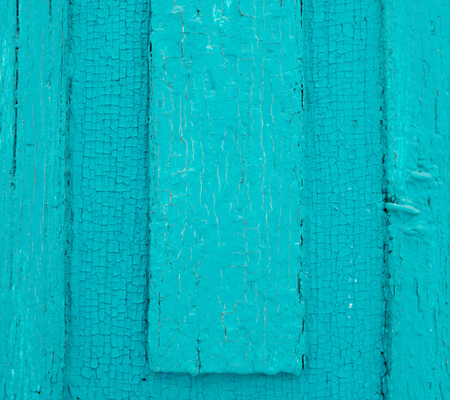 Bright blue paint on aged wooden doorの写真素材