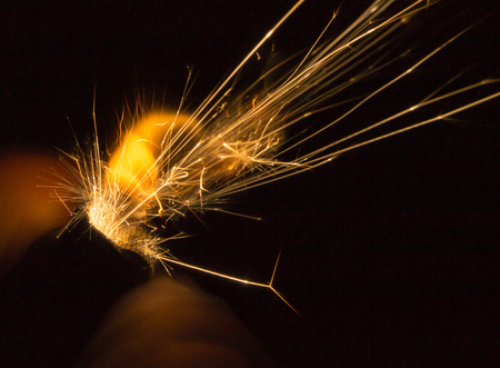 Closep details of sparks from a hand held ligther in the darkの写真素材