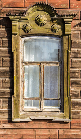 A fading green painted ornate Russian window frame on a public houseの写真素材