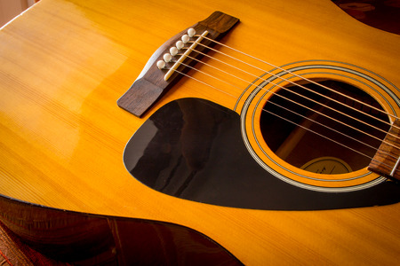 Large acoustic guitar with sound hole and pickguardの写真素材