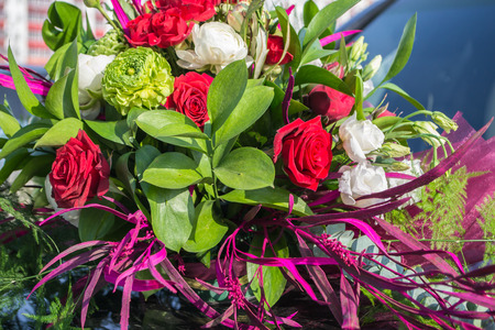 A display of rose  flowers sits on a car for a wedding coupleの写真素材