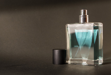 An unused fresh bottle of aftershave with a black lidの写真素材