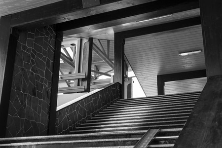 Covered walkway with steps leading to the main area in black and whiteの写真素材