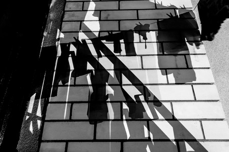 Silhouette of clothes hanging at night in black and whiteの写真素材