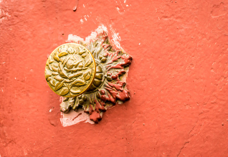 Single brass doorknob roughly painted in red paintの写真素材
