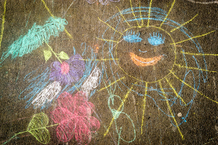 Child chalk drawing on grey asphalt in various colorsの写真素材