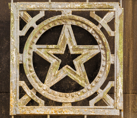 Aged soviet Russian Star in wrought iron with flakes and signs of ageの写真素材