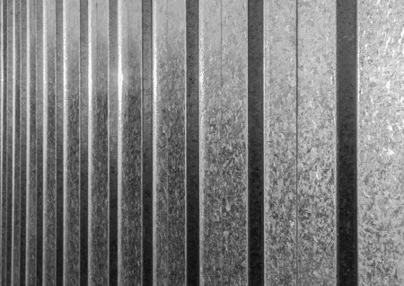 Abstract black and white stainless steel fencing sheet in sunlightの写真素材