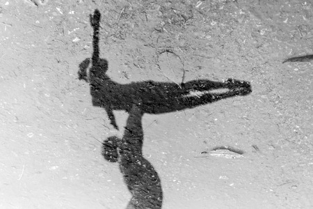 Closeup of Man and Woman ballet dancers in stone reflected on water in black and whiteの写真素材