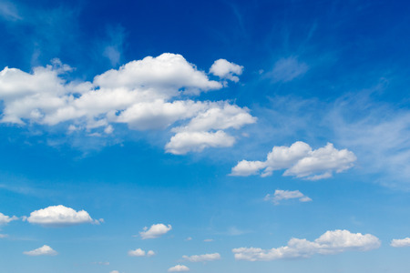 White clouds against a bright blue skyの写真素材