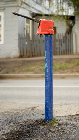 Blue and red traditional hand water pump common in Russiaの写真素材