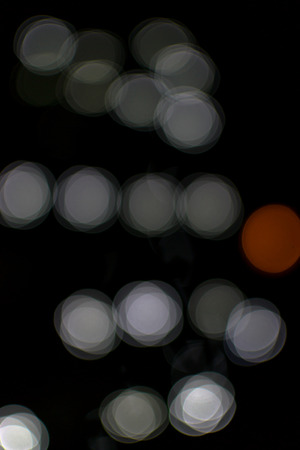 Red and white bokeh blurred light effect using a black backgroundの写真素材