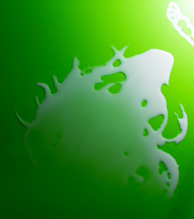White Water swirls on the surface of green plasticの写真素材