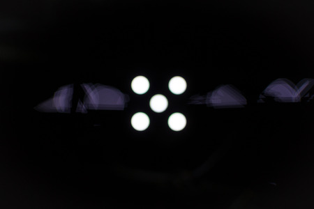 Five white dots on a black background with light defraction in a horizontal positionの写真素材