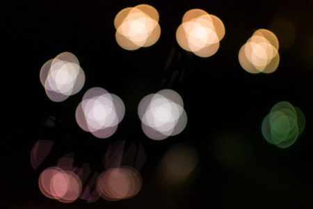Bokeh blurred light effect using a black backgroundの写真素材