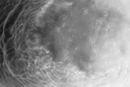 Underwater shot of water pouring into a bathの写真素材