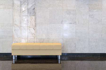 Modern sofa shot against a marble wallの写真素材