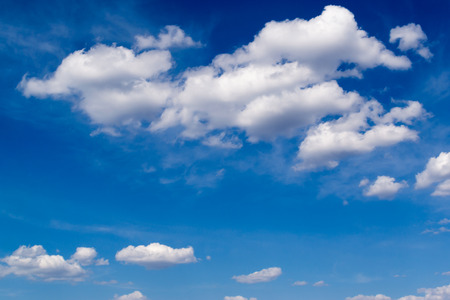 White clouds against a bright blue skyの写真素材