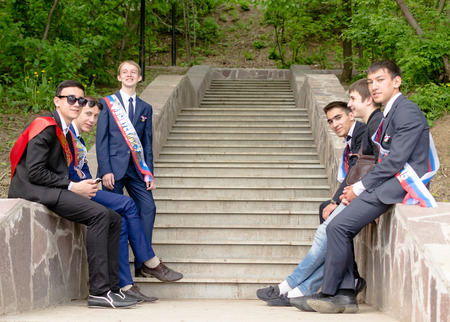 Group of 6 Russian school kids relaxing after graduation from high school in May 2015のeditorial素材