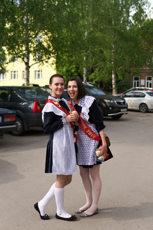 Two Russian schoolgirls in Uniform celebrating graduation from Highschool in Ufa May 2015のeditorial素材