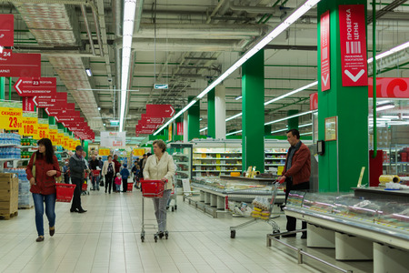 People shopping in a modern style Russian supermarket in 2015 with a wide range of consumer productsのeditorial素材