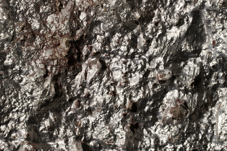 Sun baked silver paint on a brick wallの写真素材