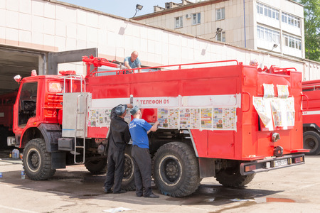 Firemen in Ufa Russian redecorating a fire vehicle in the summer heat of May 2015