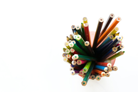 Overhead view of multicolored coloring pencils in pots isolated on white backgroundの写真素材