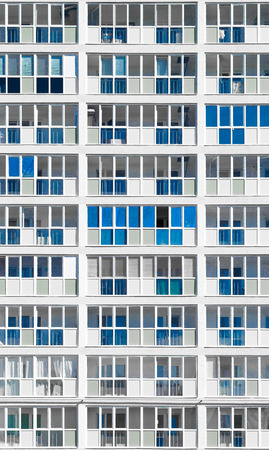 Modern housing apartments in unsaturated color and highlighted blue exterior decorationの写真素材