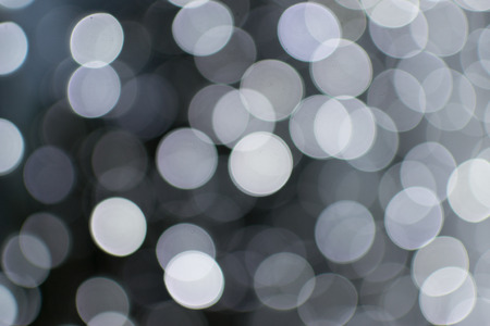 Many blurred white celebration fairy lights create abstract patternsの写真素材