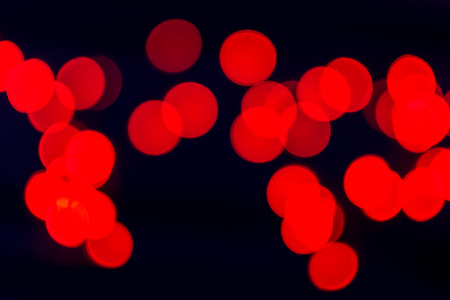 Many blurred red celebration fairy lights create abstract patternsの写真素材