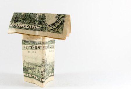 Single paper house made from US dollar bills including a 100 noteの写真素材