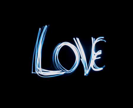 Single love text painted in blue light in the darknessの写真素材
