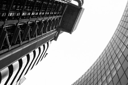 Futuristic modern building abstract with curving building glass windows and a clean white sky with nobody visibleのeditorial素材