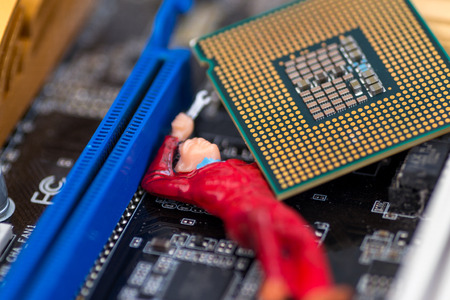 Technical Workman miniature toy works on fixing a broken home computer PC or notebookの写真素材