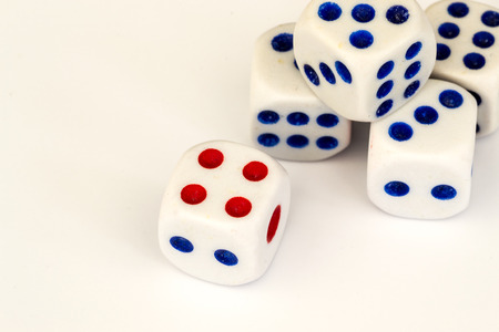 Five blue and red spotted gambling dice on a white background in a close up macro studio shotの写真素材