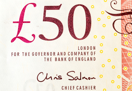 Macro close up of a single British fifty pound note showng the Bank of England currency value and...