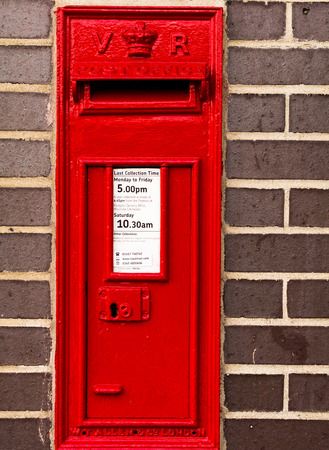 14 Aug - Red Postal box set in a brick wall offering a safe way for people to post their letters in August 2015 in Witham Englandの写真素材