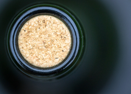 Macro closeup of an unopened green glass wine bottle with an unused oak corkの写真素材