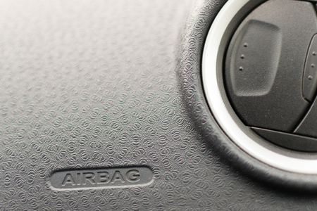 Grey car interior with Airbag sign and an air conditioning vent with nobody in viewの写真素材